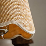Close-up of the textured woven lamp shade with scalloped trim and natural fiber detail.