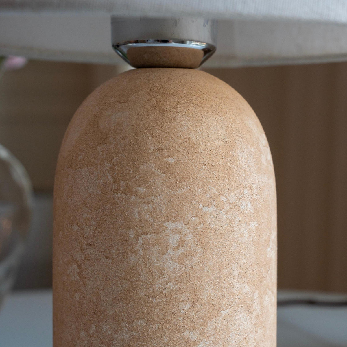Close-up of the textured sandstone lamp base showing its natural stone-inspired finish.