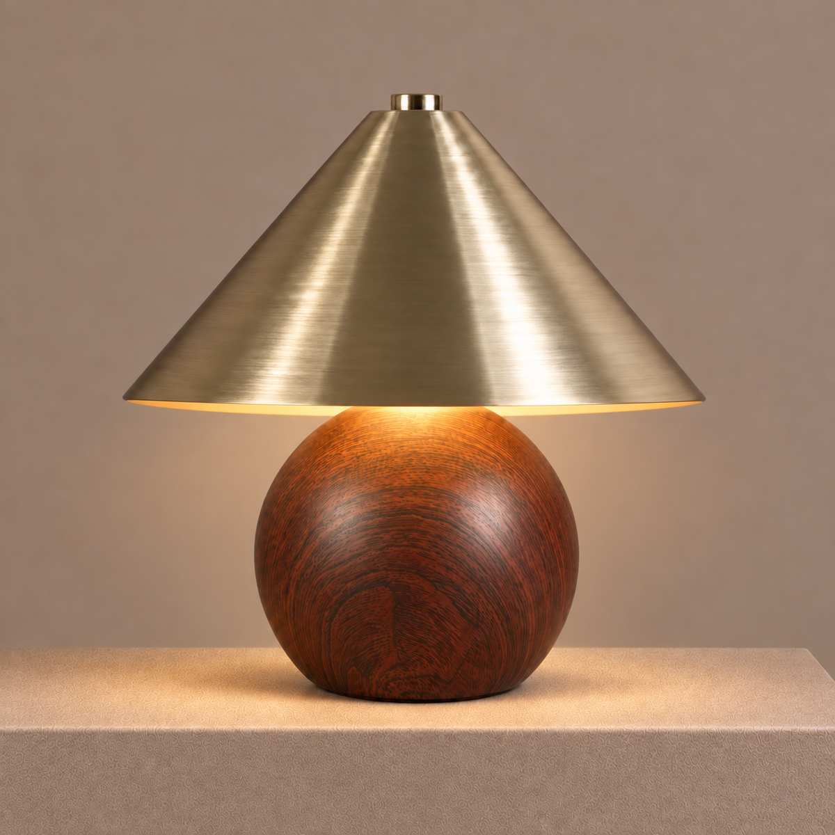 Illuminated brass table lamp with a dark woodgrain base casting a warm ambient glow.