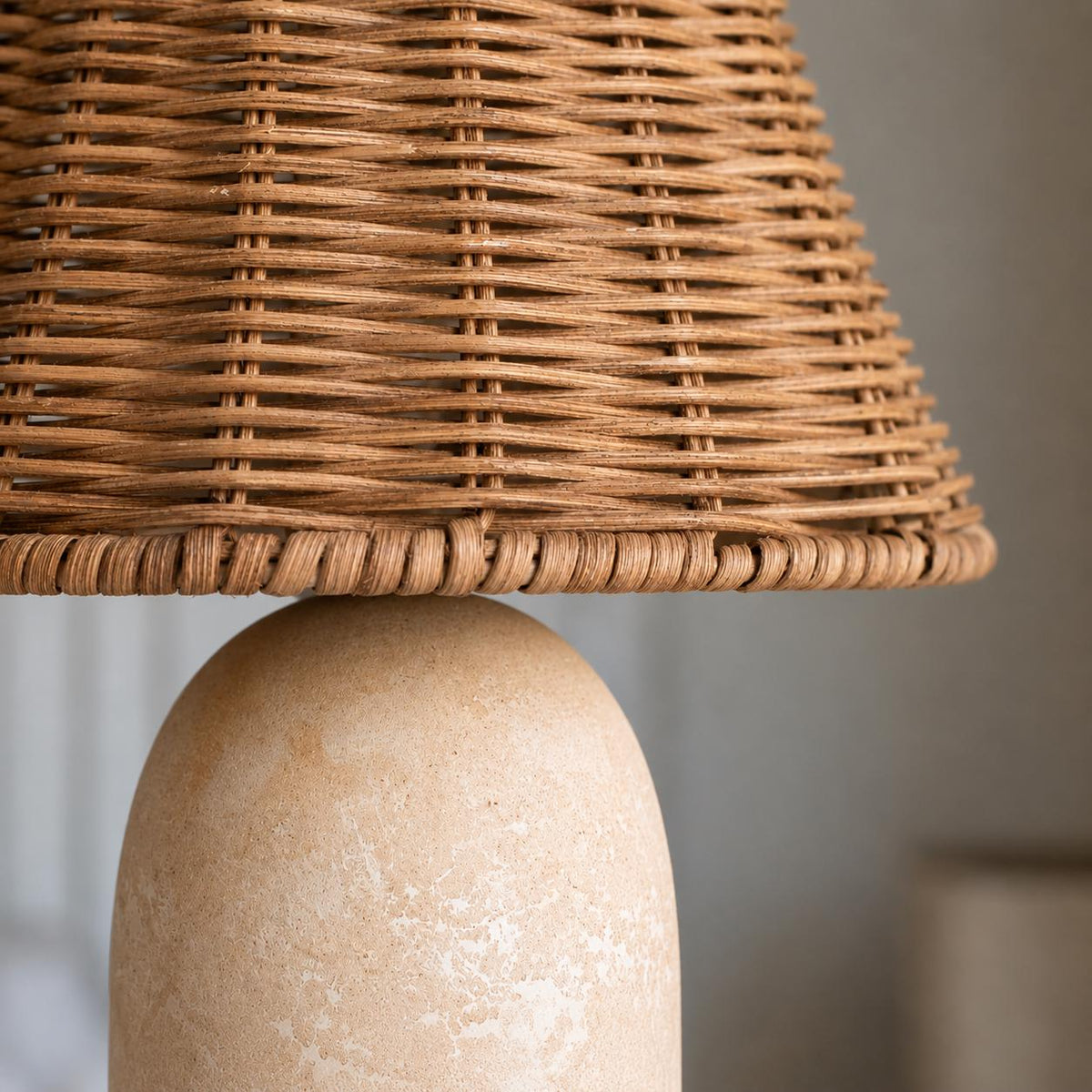 Close-up of the woven rattan lamp shade and textured sandstone ceramic base.