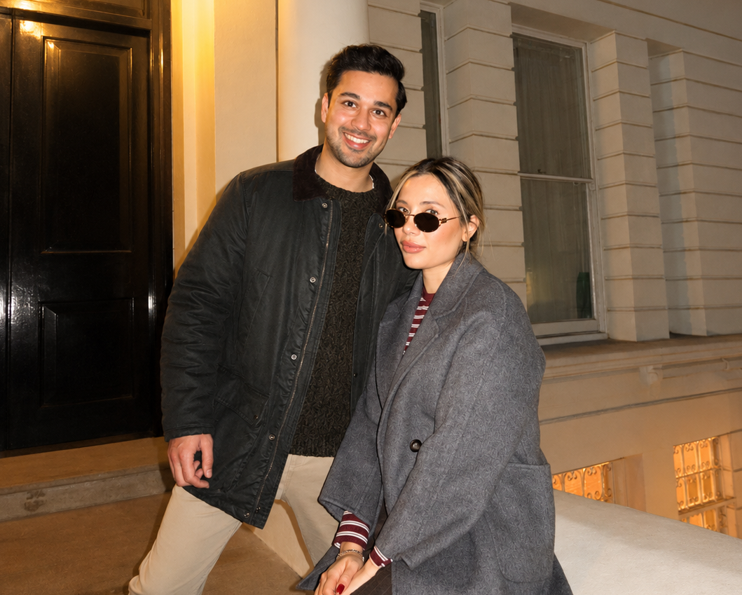 Ora Collective Home founders posing together outside a classic London townhouse at night, wearing layered neutral outerwear.