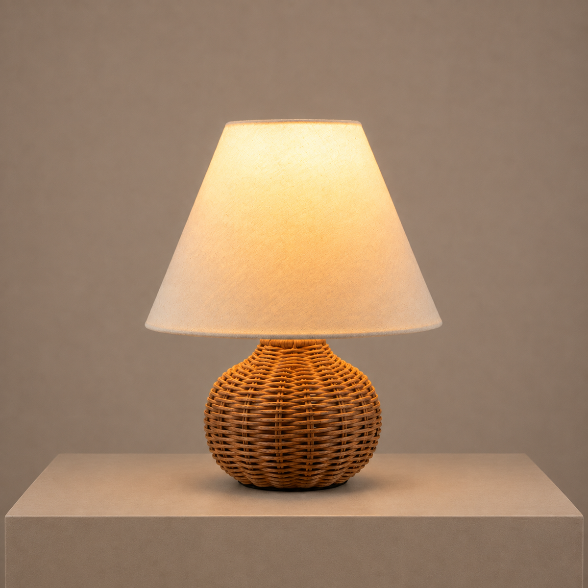 illuminated woven rattan table lamp with a warm glow and white fabric shade